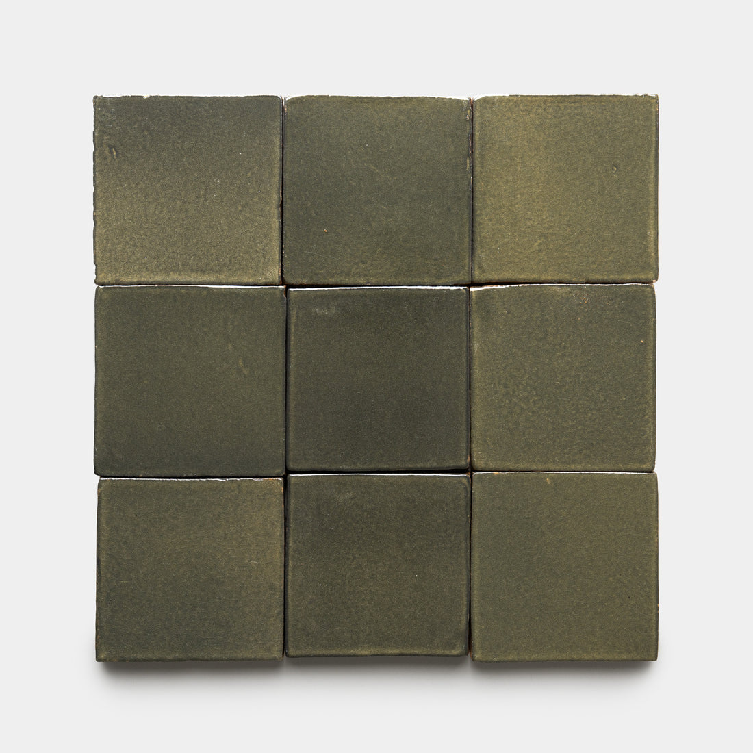 Nine Oyamel 4x4 Square ceramic tiles by Zia Tile, in olive green matte finish with slightly uneven, handmade-style surfaces, are arranged in a 3-by-3 grid on a white background.