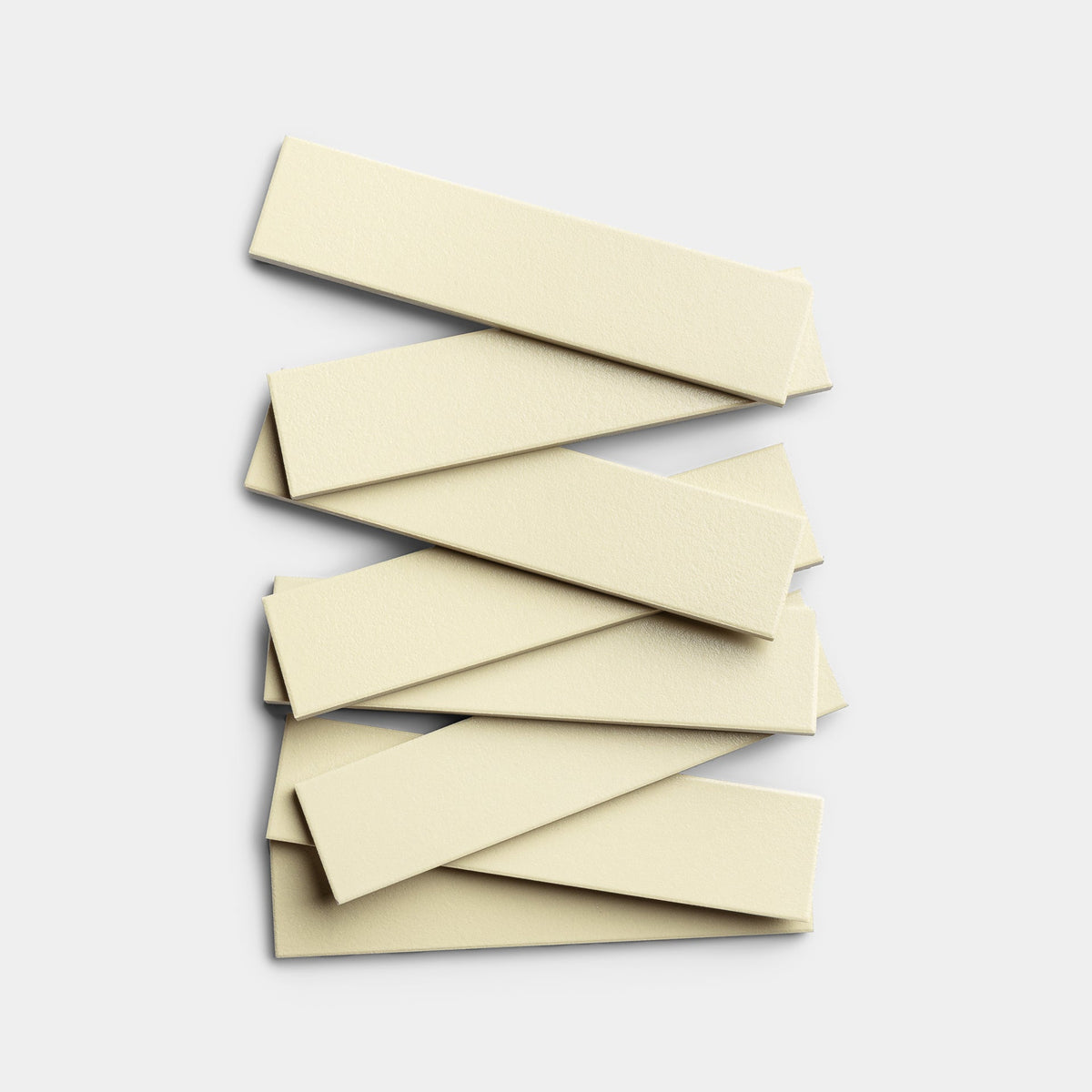 Eight rectangular Pale Ochre 2x8 tiles by Zia Tile are stacked unevenly on a plain white background.