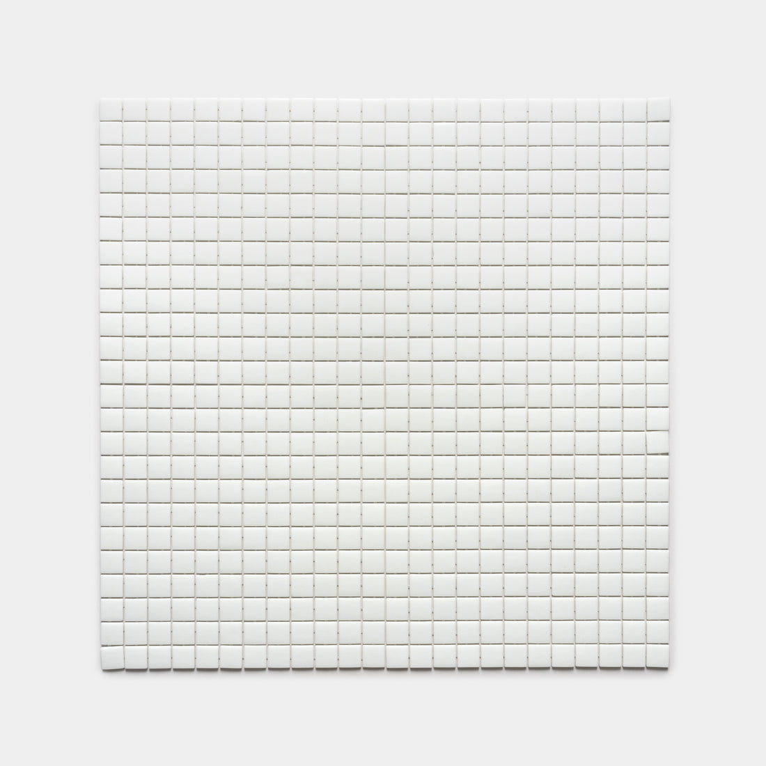 A square grid of Zia Tile’s Paperwhite 1x1 tiles, small, white, and evenly spaced on a plain white background.