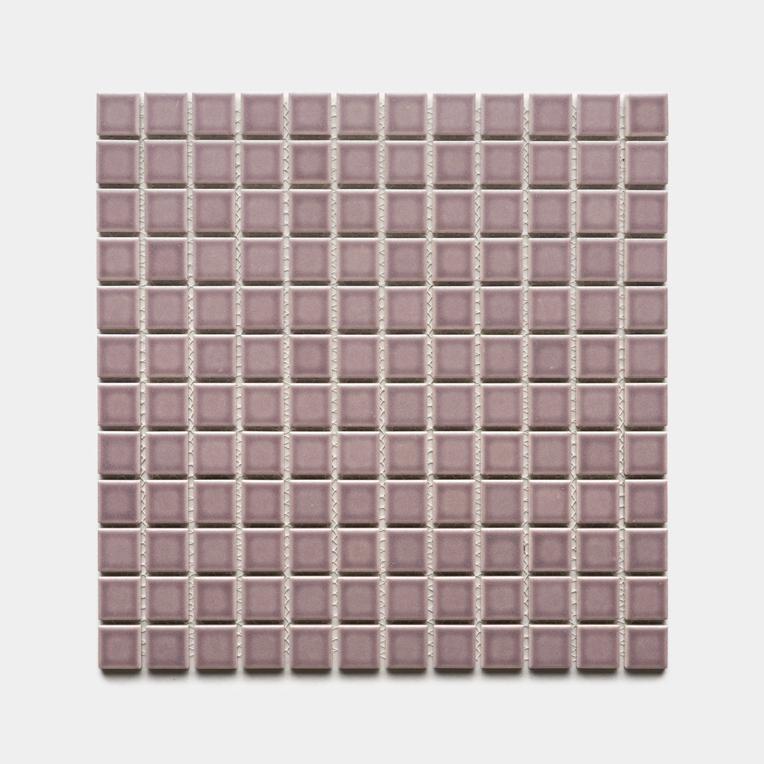 A square sheet of Zia Tile Patchouli 1x1 small, glossy mosaic tiles in mauve, arranged in a grid pattern on a white background.