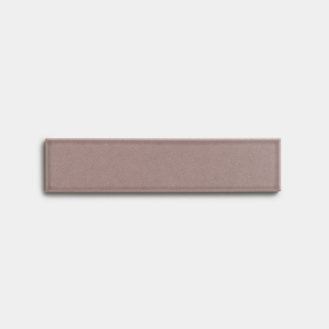 A single Patchouli 2x8 mauve ceramic tile by Zia Tile, featuring a smooth matte finish, is centered on a plain white background.