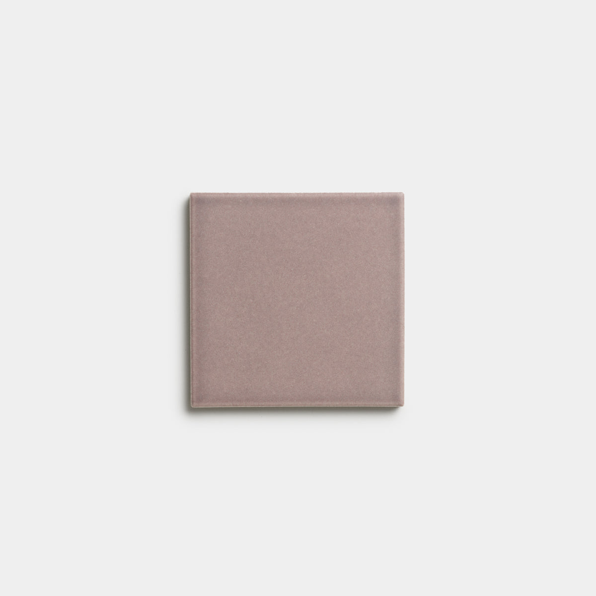 A single Patchouli 4x4 ceramic tile by Zia Tile in muted mauve, centered on a plain white background.
