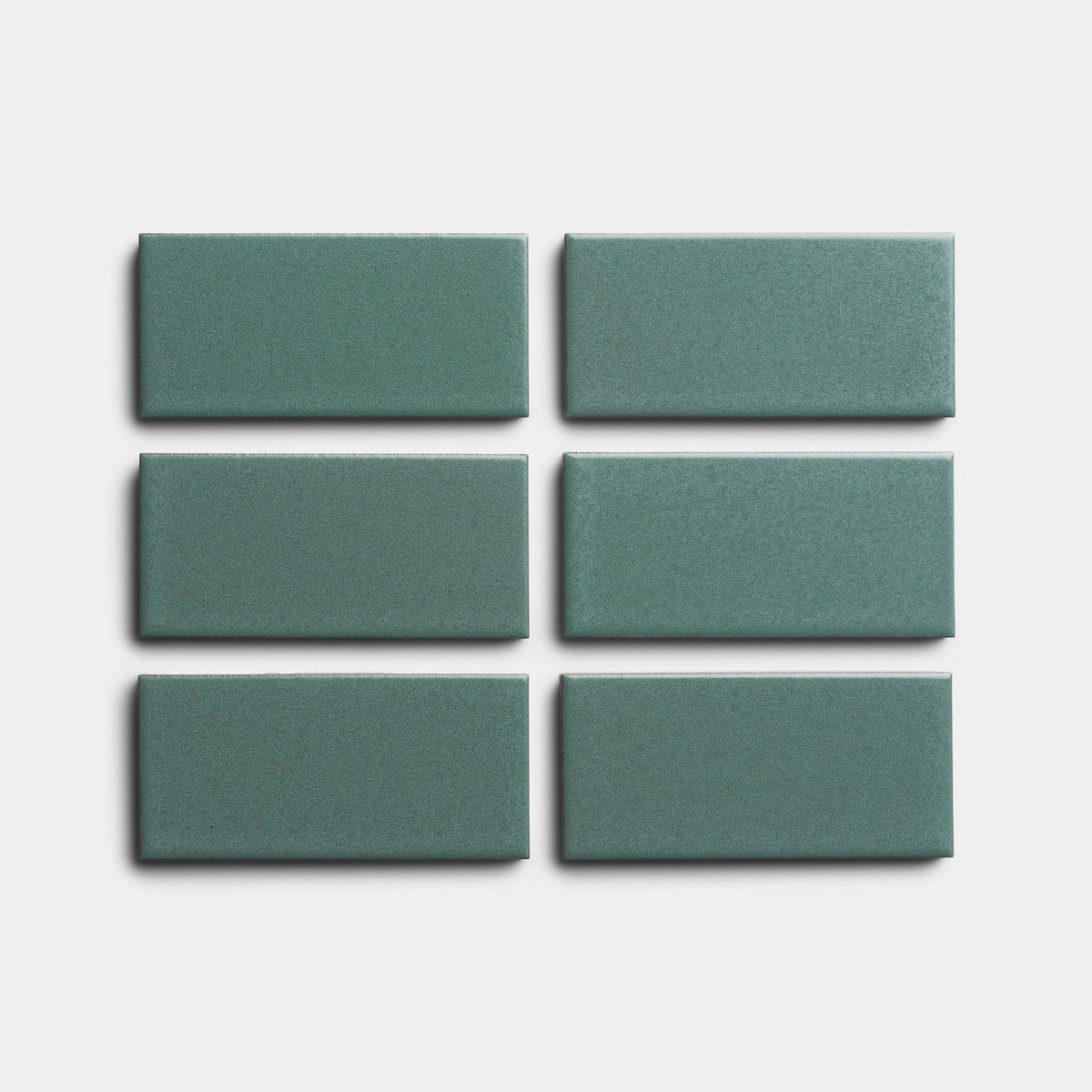 Six Patina 2x4 tiles by Zia Tile, rectangular and green, are arranged in two rows of three on a plain white background.