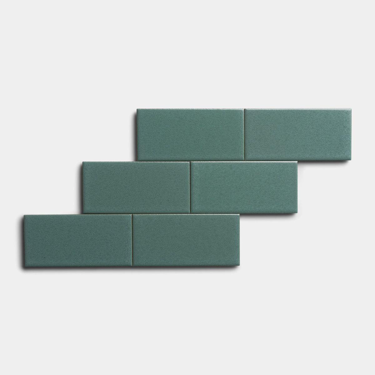 Five Patina 2x4 tiles by Zia Tile are arranged in a staggered, offset brick pattern on a plain white background.