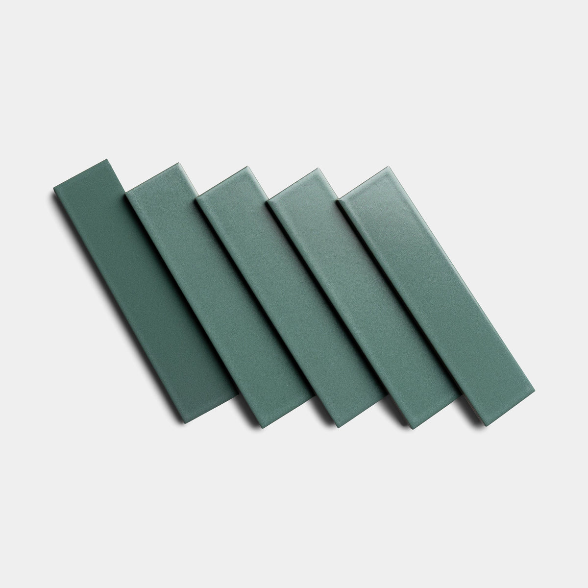 Five rectangular Patina 2x8 tiles by Zia Tile are arranged diagonally in a staggered, overlapping pattern on a plain white background.