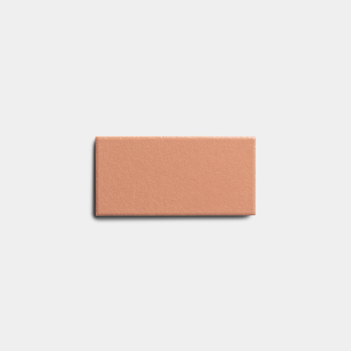A single Pecan 2x4 tile sample by Zia Tile, featuring a smooth matte light brown terracotta surface, is shown against a plain white background.