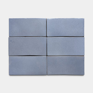 Six rectangular, smooth, blue-gray Pedregal 4x8 Rectangle tiles by Zia Tile are arranged in two rows of three on a plain white background.