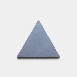 A single Pedregal Triangle tile by Zia Tile, featuring a solid blue equilateral shape, is centered on a plain white background.