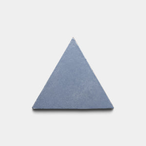 A single Pedregal Triangle tile by Zia Tile, featuring a solid blue equilateral shape, is centered on a plain white background.