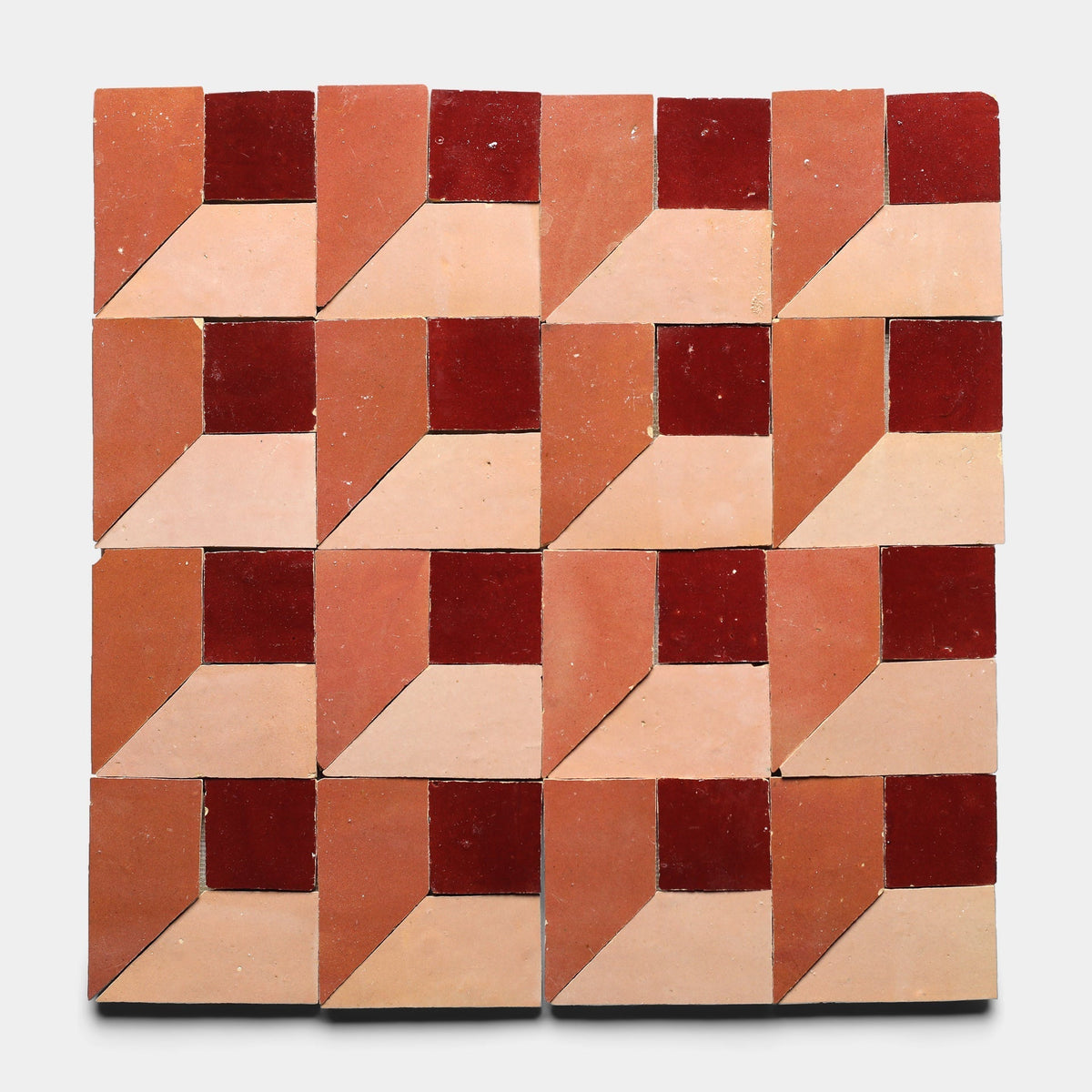 Perpetual Check 3 by Zia Tile features 16 squares on a crisp white background, each divided into dark red, burnt orange, and light pink to create an optical illusion of three-dimensional cubes.