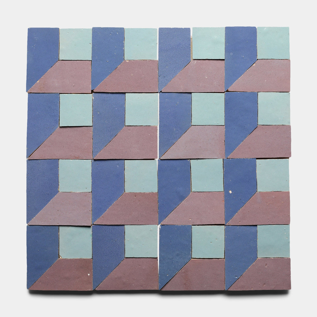 The Perpetual Check 4, Sample by Zia Tile is a set of 16 handmade tiles featuring blue, teal, and mauve geometric patterns that interlock to form a three-dimensional optical illusion on a white background.