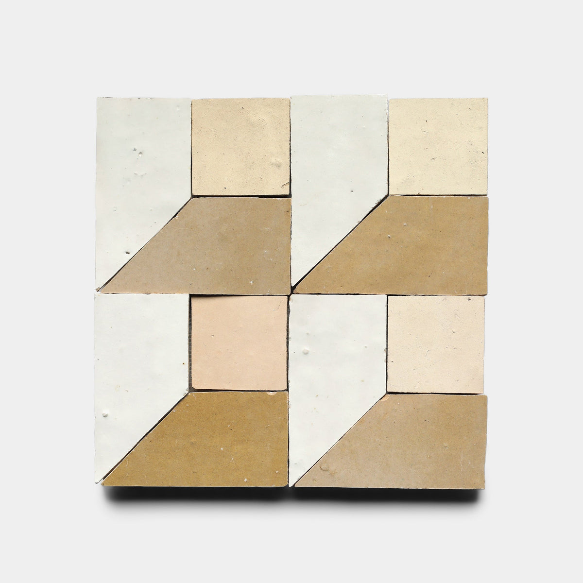 Perpetual Check 5, a Zia Tile sample, features a geometric arrangement of beige, tan, and off-white tiles forming symmetrical squares and trapezoids on a light gray background.