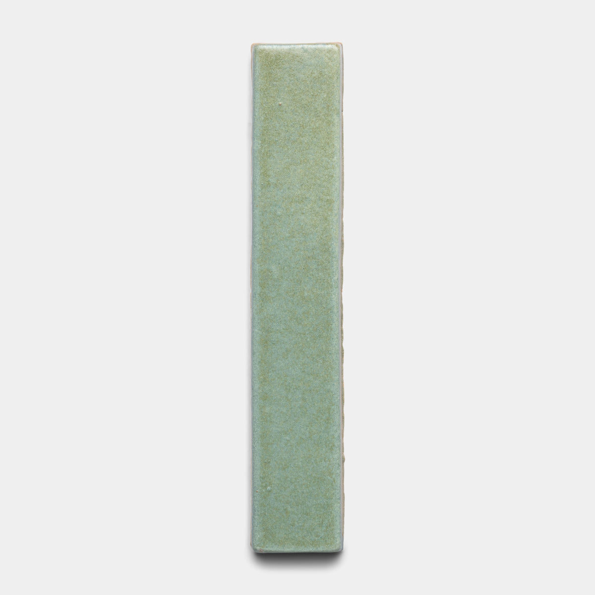The Peyote Mini Bar by Zia Tile is a single rectangular ceramic tile with a smooth, light green surface and slightly rounded edges, displayed vertically against a plain white background.