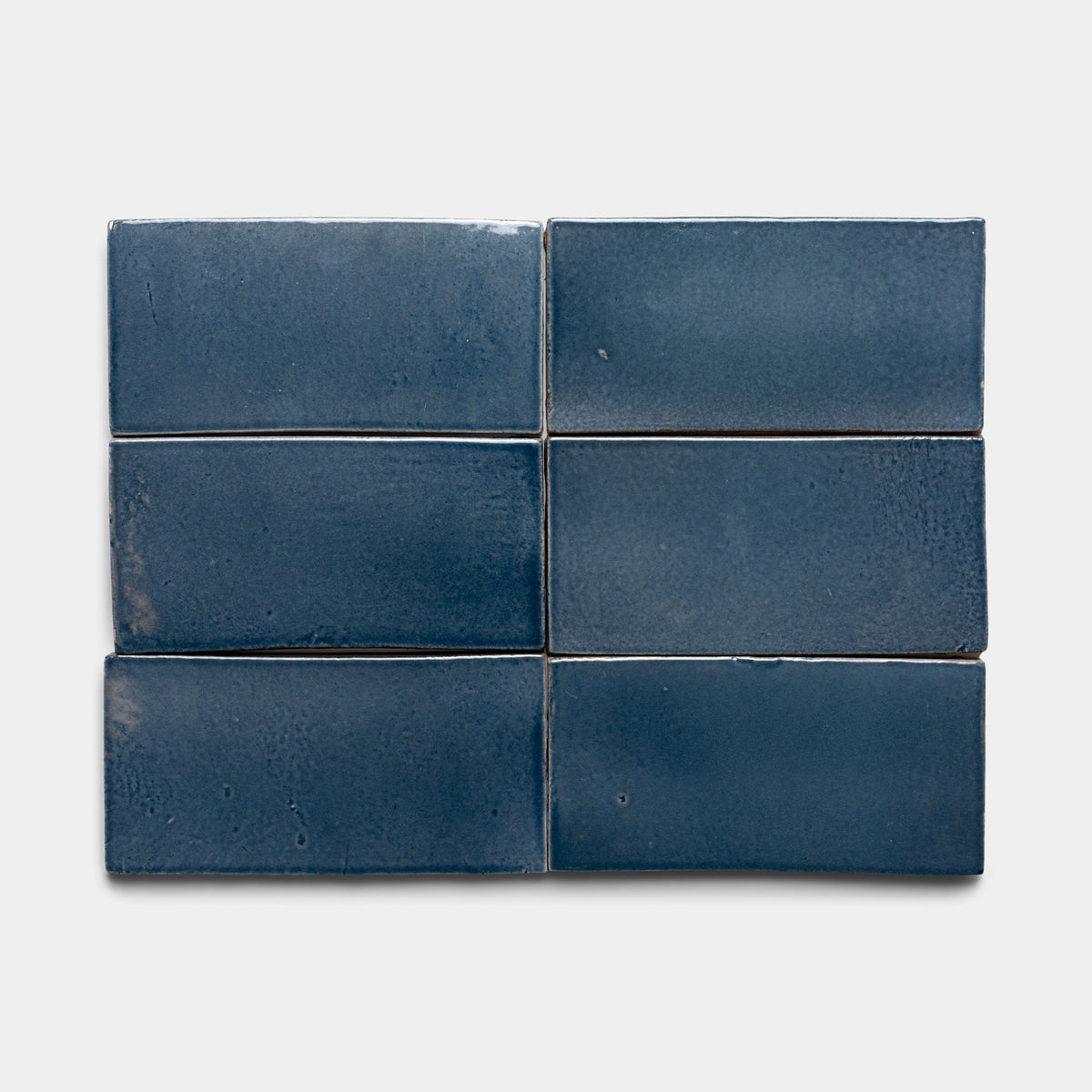 Six glossy blue Piedra 4x8 Rectangle tiles by Zia Tile, arranged in two rows of three, displayed on a plain white background.