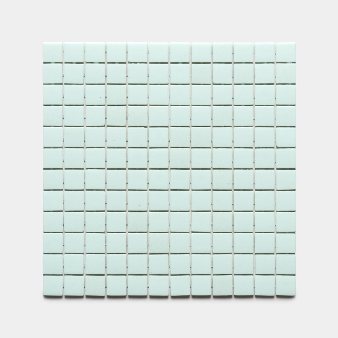 A rectangular grid of small Piscine 1x1 light blue square tiles by Zia Tile is arranged in neat rows and columns on a plain, light gray background.
