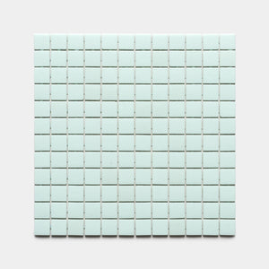 A rectangular grid of small Piscine 1x1 light blue square tiles by Zia Tile is arranged in neat rows and columns on a plain, light gray background.