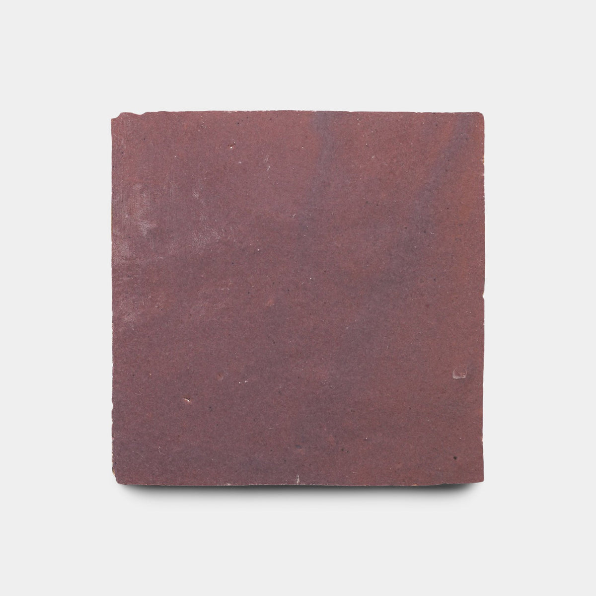 The Gypsum 4x4 sample by Zia Tile is a square, handmade tile in reddish-brown with a flat, rough, slightly uneven surface, displayed on a plain white background.