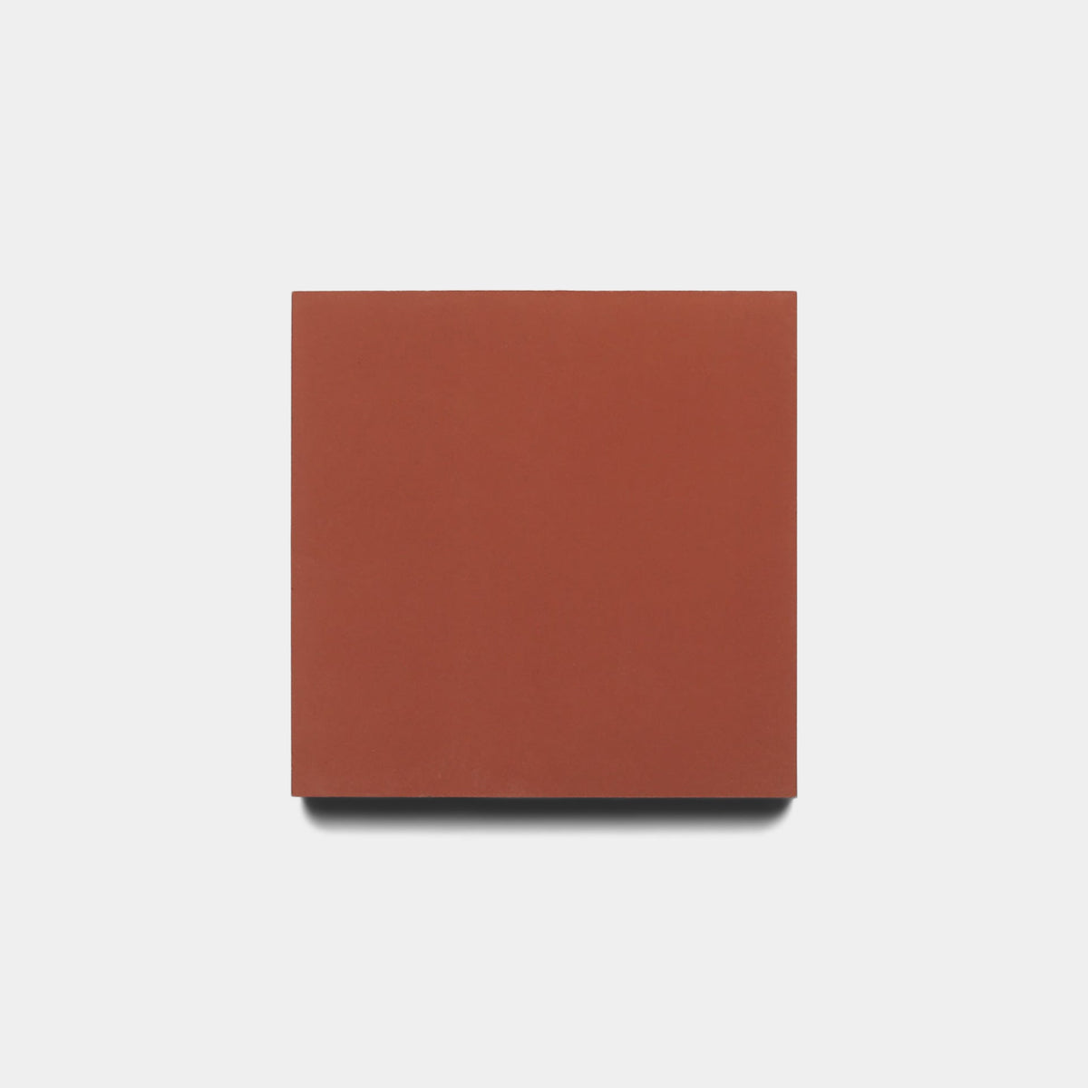 A Pompeii 4x4 tile sample by Zia Tile, in a plain square shape with terracotta coloring, is centered on a white background and casts a faint shadow below.