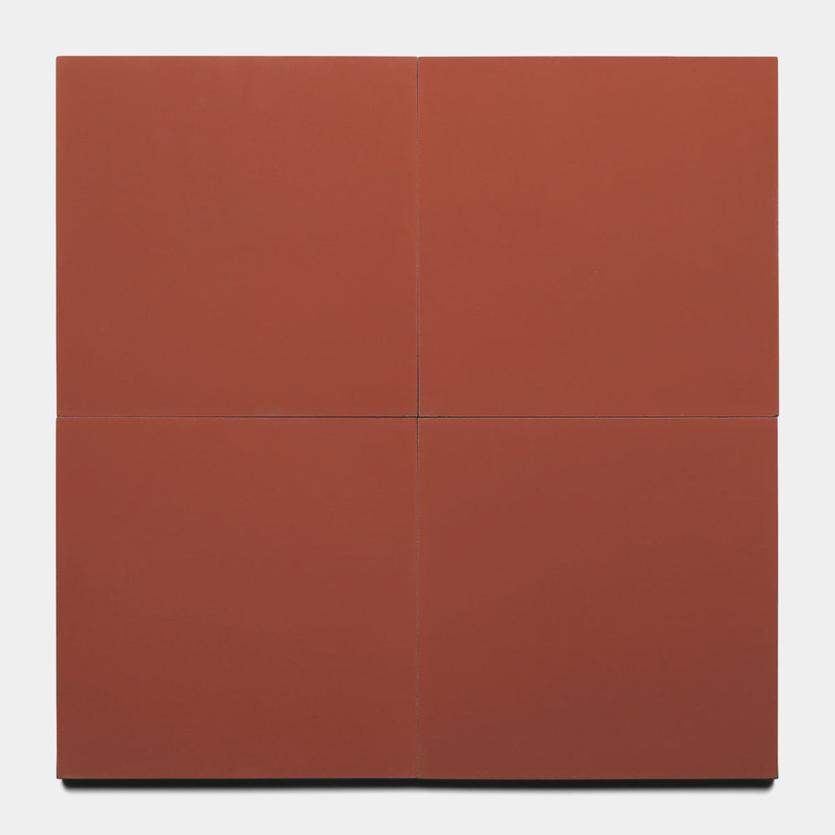 A minimalist artwork inspired by Zia Tile's Pompeii 8x8 Sample, featuring four matte terracotta red square panels in a grid with fine lines between each, all set against a crisp white background.
