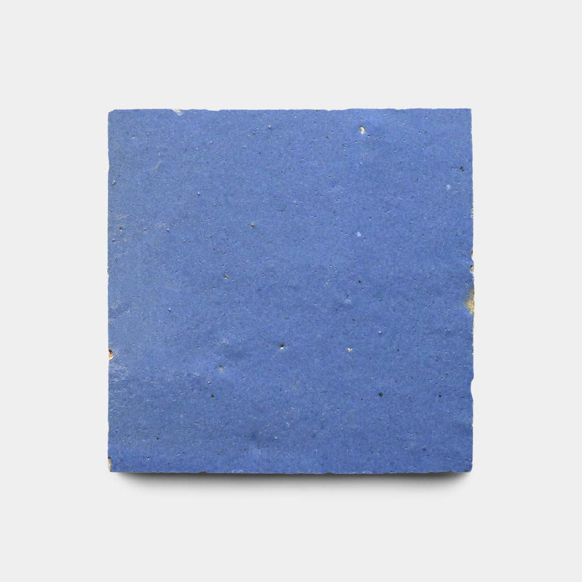 A rectangular, flat, Portuguese Blue 2x6 ceramic tile sample from Zia Tile with a slightly rough texture and minor imperfections, set against a plain white background.