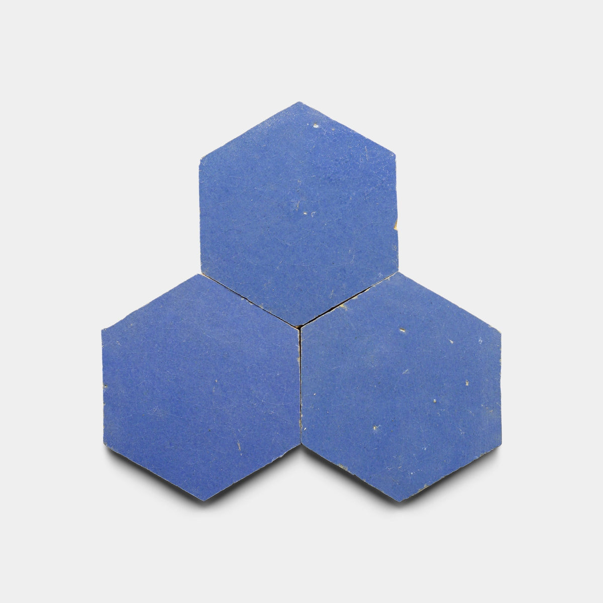 Three Portuguese Blue 2x6 tile samples by Zia Tile are clustered on a white background, their edges touching to form a geometric arrangement.