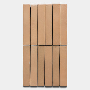 Twelve Posada Mini Bar tiles by Zia Tile are arranged upright in two neat rows of six against a plain white background.