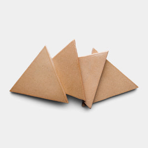 Four brown Posada Triangle tiles by Zia Tile are arranged overlapping each other on a plain white background.