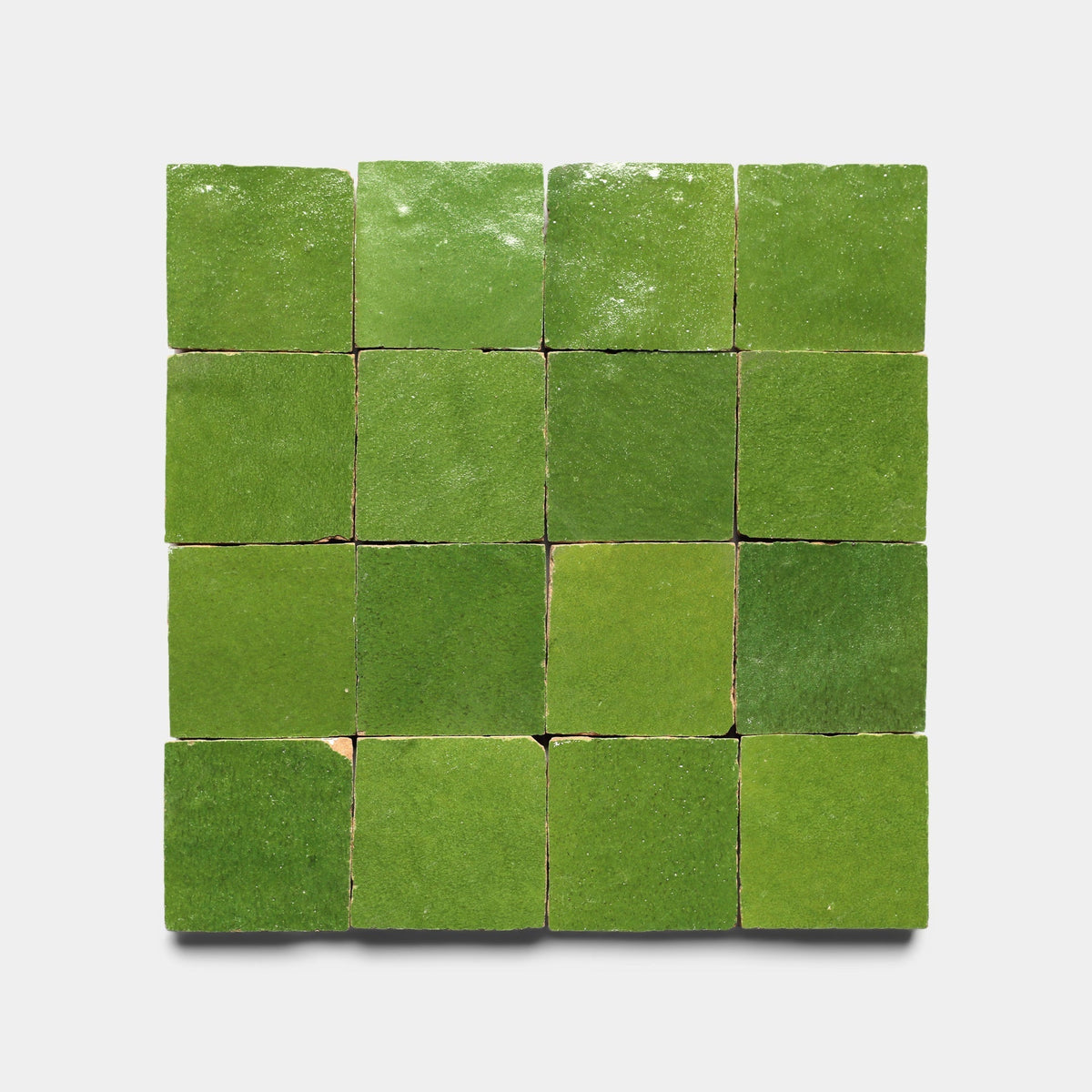 A grid of sixteen Prairie Green 2x2 handmade tiles by Zia Tile, each square with unique shade and texture variations, arranged in four rows and four columns on a plain white background.