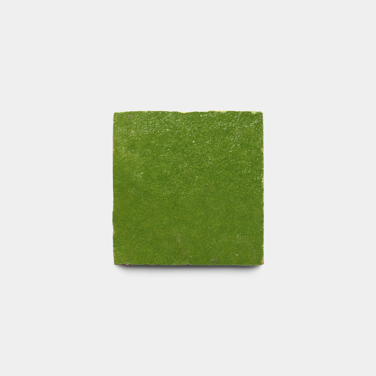 A single Prairie Green 2x2 handmade tile by Zia Tile, featuring a glossy finish, is centered on a plain white background.