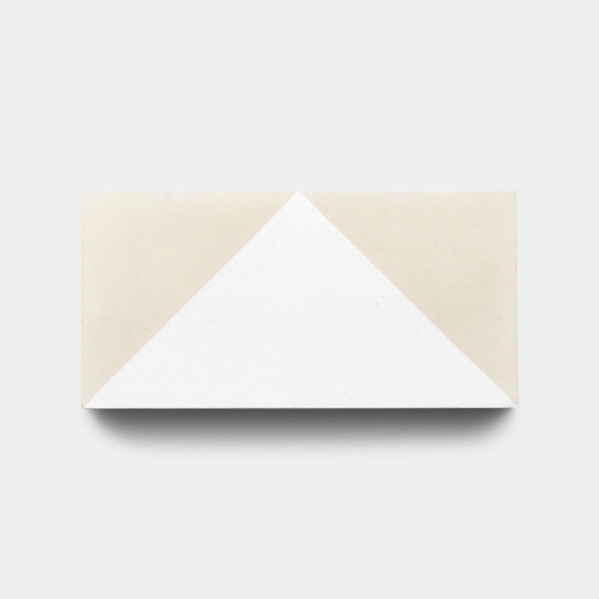 The Press Play Nile 4x8 sample by Zia Tile is a rectangular tile featuring a geometric design with a central white triangle, light beige triangles on each end, and a light gray background.