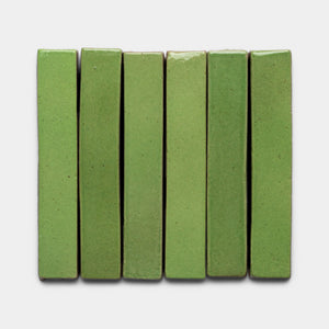 Six Primavera Mini Bar chocolates by Zia Tile are arranged vertically side by side on a plain white background. Each bar features a smooth, glossy green matcha surface with even edges.