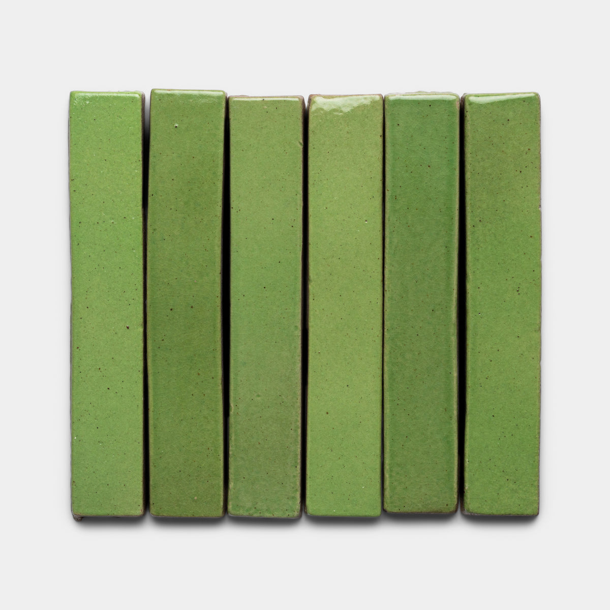Six Primavera Mini Bar chocolates by Zia Tile are arranged vertically side by side on a plain white background. Each bar features a smooth, glossy green matcha surface with even edges.
