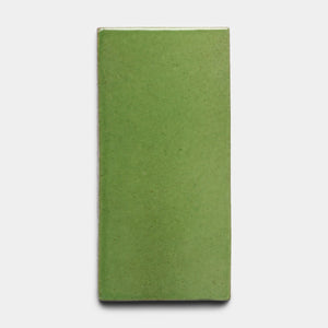 The Primavera 4x8 Rectangle tile by Zia Tile, a glossy green ceramic rectangle, is centered against a plain white background.