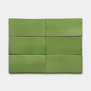 Six Zia Tile Primavera 4x8 Rectangle green ceramic tiles, with a smooth, slightly glossy finish, are arranged in two rows of three on a plain white background.