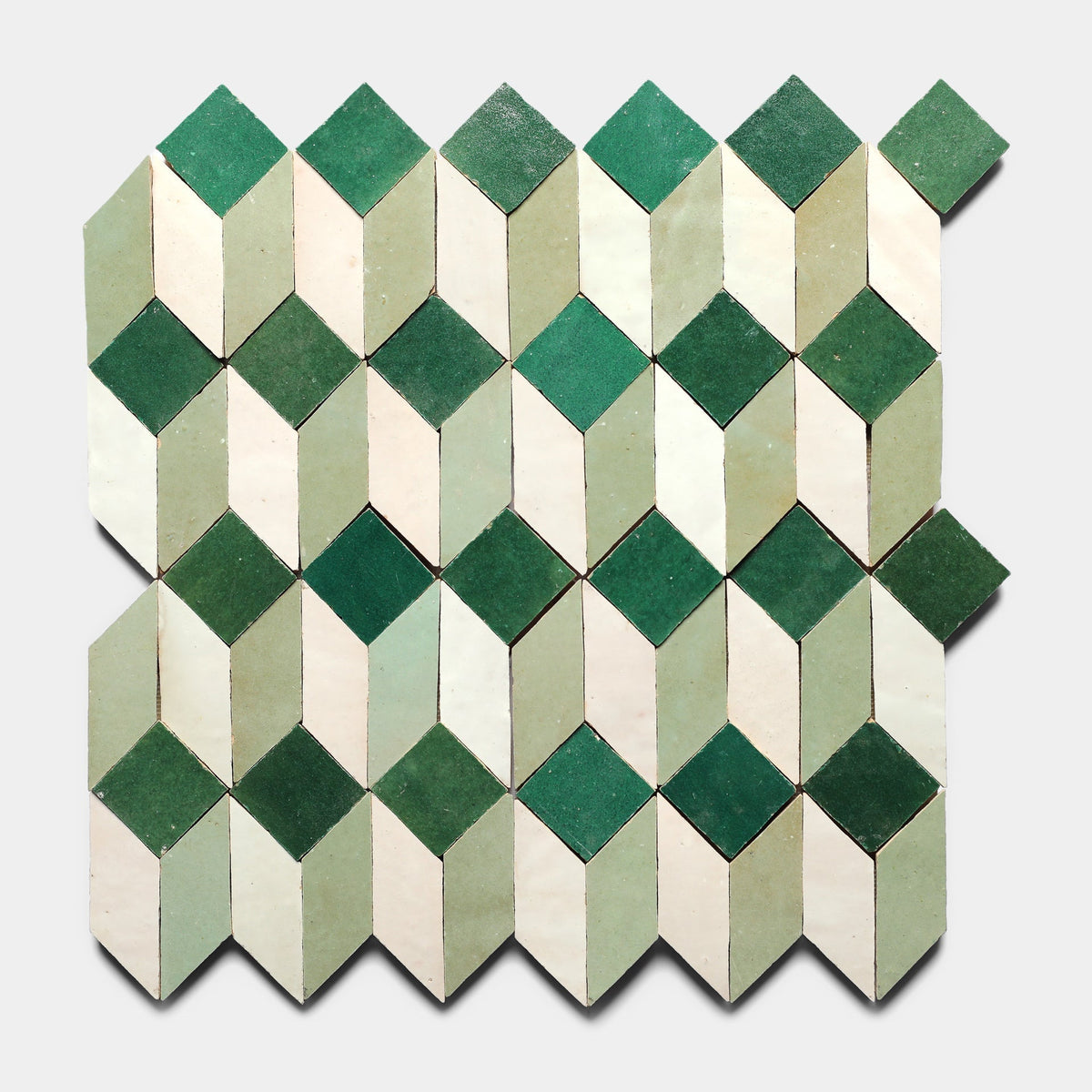 The Prismatic 4, Sample by Zia Tile features a geometric pattern of green and cream rhombuses that form a 3D cube illusion, inspired by Moroccan tile designs and set on a light gray background.
