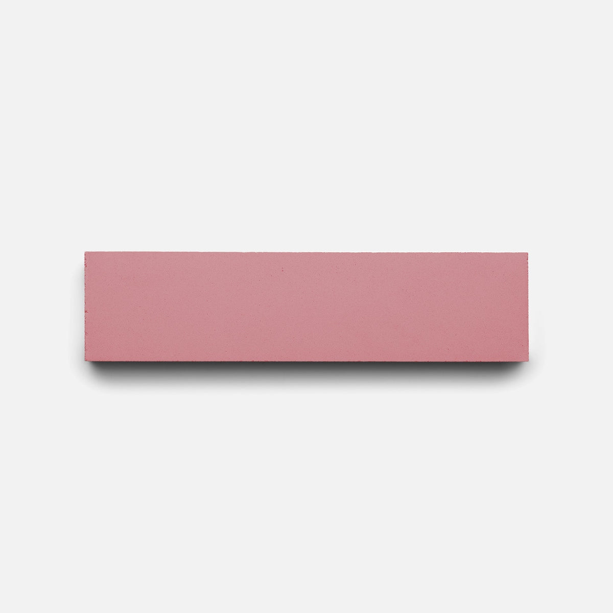 A Protea 2x8 tile sample by Zia Tile rests flat on a plain white background, casting a faint shadow beneath it.
