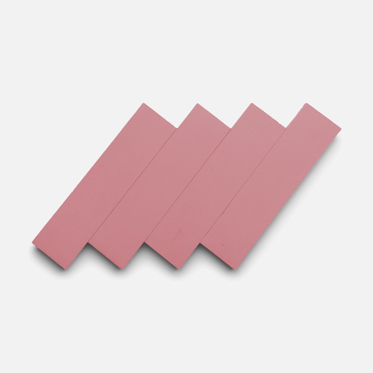 Four Protea 2x8 sample tiles by Zia Tile in pink are arranged diagonally and overlap each other to create a zigzag pattern against a plain white background.