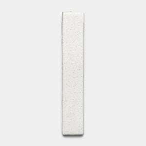 The Puebla Mini Bar by Zia Tile is a rectangular, off-white ceramic tile with a slightly textured, speckled surface, displayed vertically against a plain light gray background.
