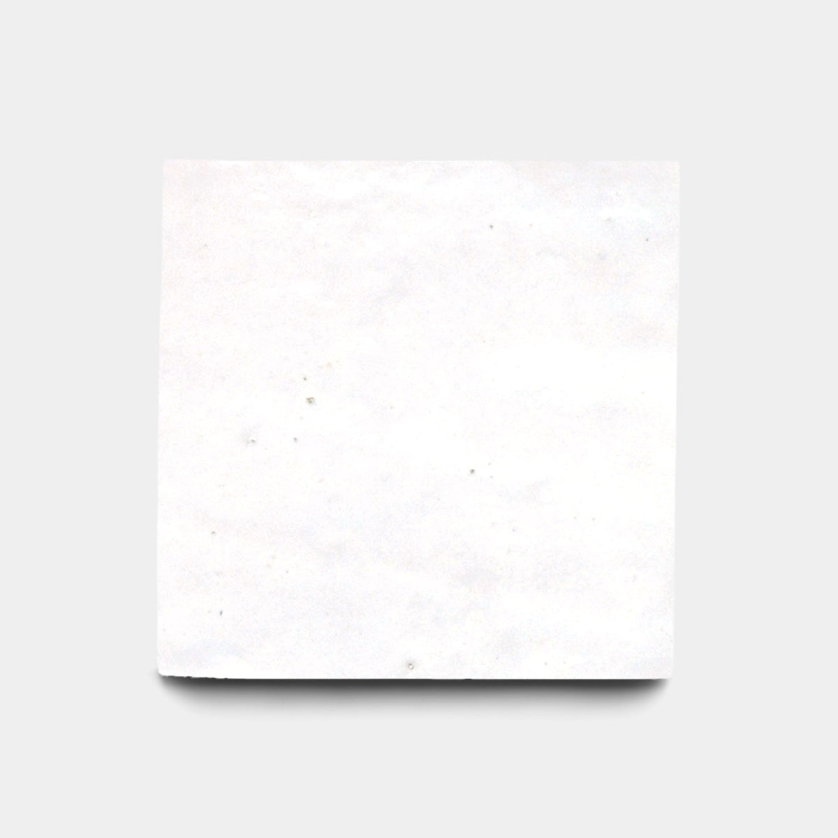 The Zia Tile Protea 4x4 sample is a handmade, plain white tile with a slightly rough texture, shown against a light gray background with a faint shadow below.