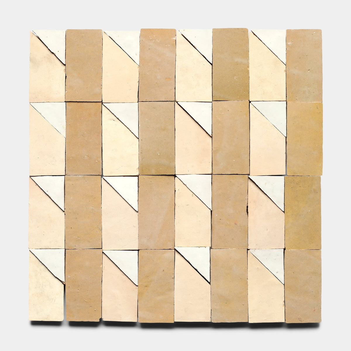 A grid of Zia Tile's Radian Inline 4 samples in beige and off-white, each with a diagonal white corner, forms a repeating geometric pattern across the square surface.