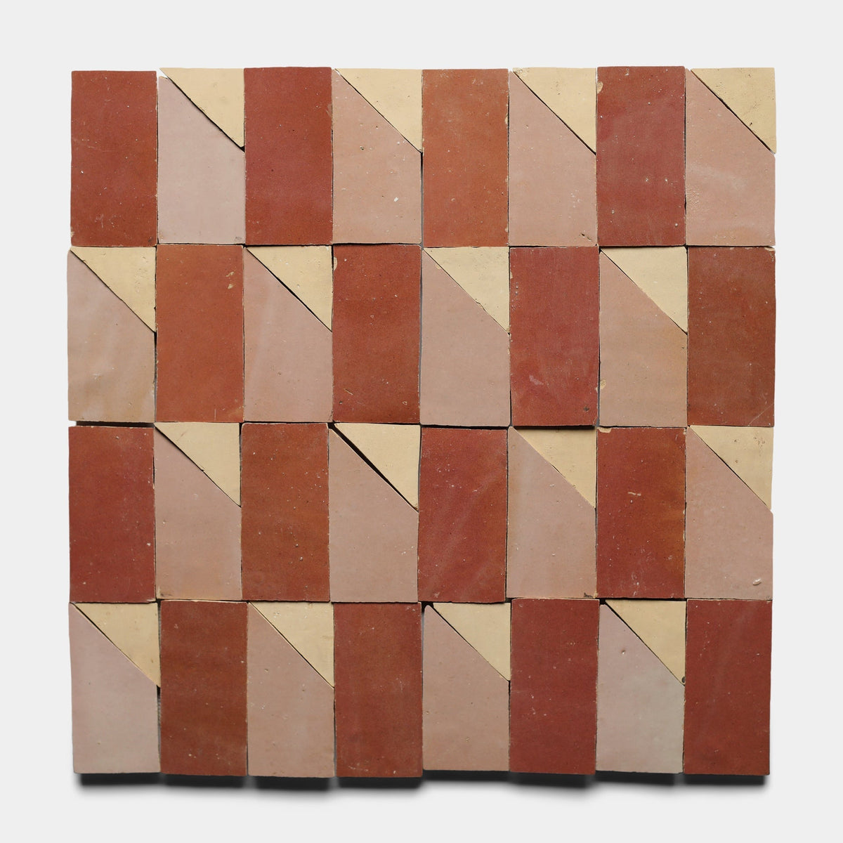 The Radian Offset 3 sample from Zia Tile features a geometric square layout with alternating red and beige triangles and rectangles for a bold, repeating design.