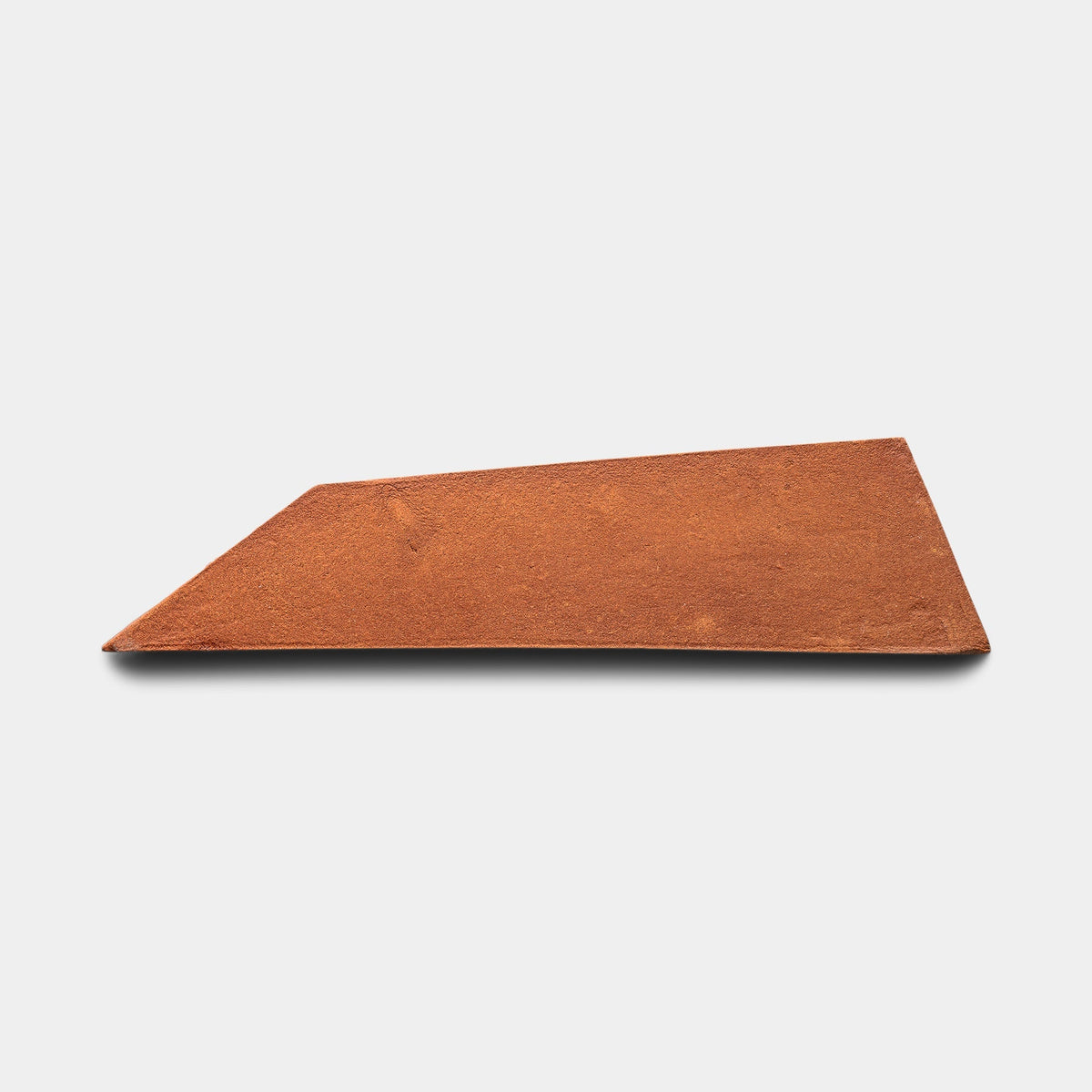 A single Tornillo + Red Clay sample from Zia Tile, a flat reddish-brown piece shaped like an irregular quadrilateral, is displayed on a plain white background.