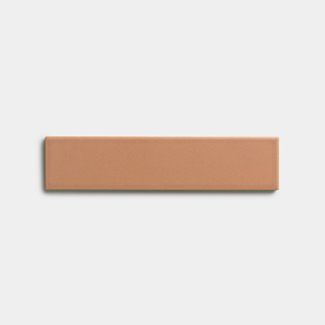 The Rhubarb 2x8 sample by Zia Tile, a rectangular tan tile, is centered on a plain white background.