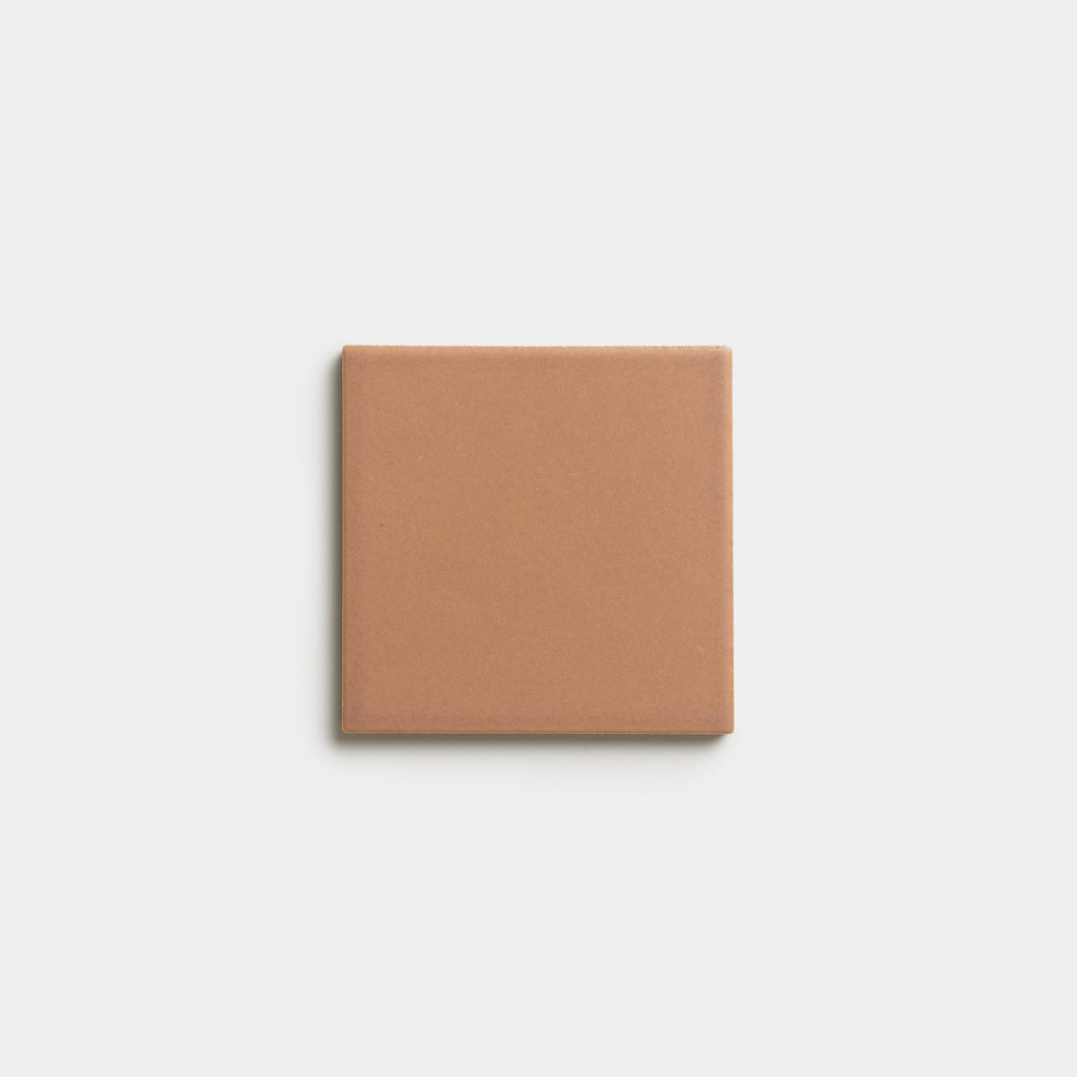 A single Rhubarb 4x4 matte light brown ceramic tile by Zia Tile is centered on a plain white background.