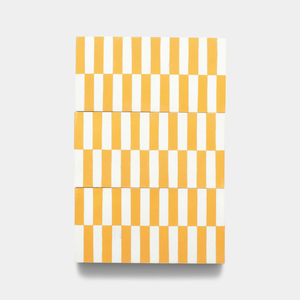 The Rialto Cadmium 4x8 sample by Zia Tile is a rectangular cement tile featuring four rows of alternating vertical yellow and white stripes on a plain light gray background.