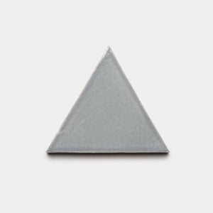 The Roca Triangle by Zia Tile, a light gray flat ceramic equilateral triangle tile, is centered on a plain white background.