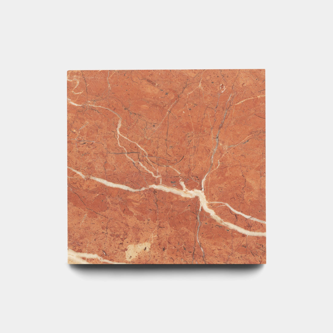 The Zia Tile Rosso Alicante 6x6 sample is a square tile of reddish-brown marble with white and light tan veining, shown on a plain white background. Its polished, glossy finish enhances the elegant natural patterns.