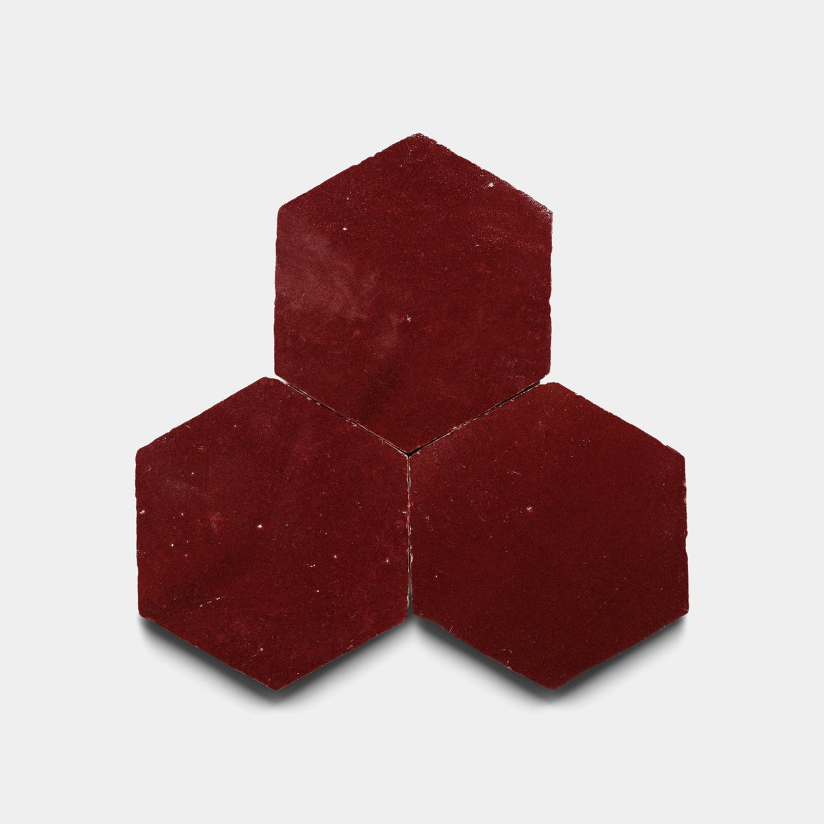 Three Rouge 2x6 tile samples from Zia Tile are arranged with two at the bottom and one centered above them on a plain white background.