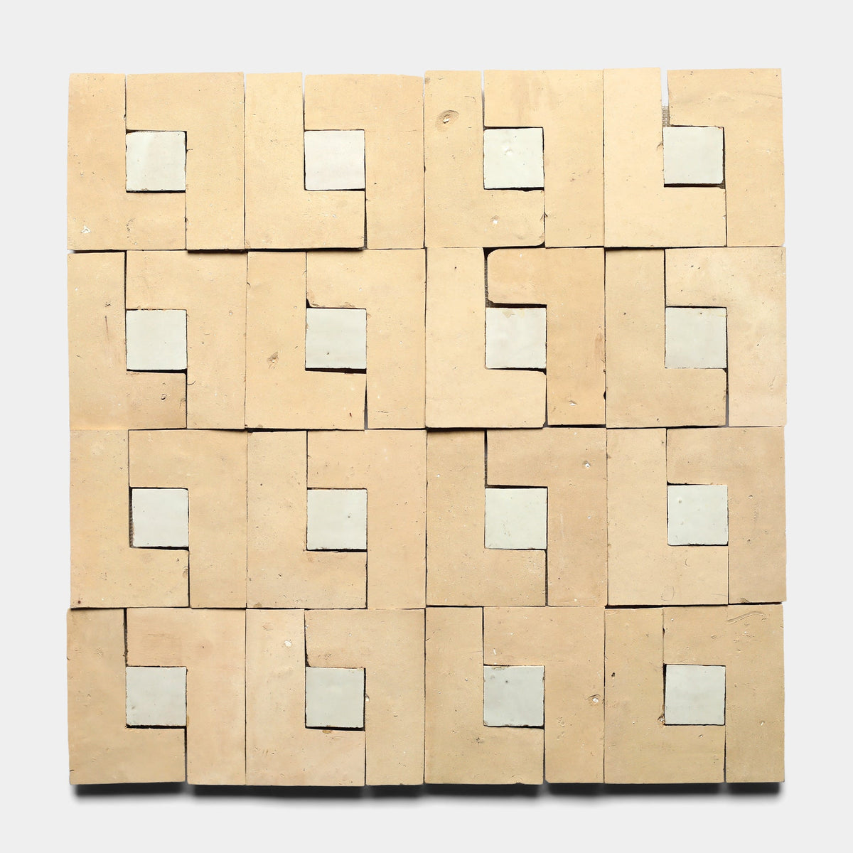 Rubric 2, Sample by Zia Tile features 16 square tiles with handmade geometric beige and off-white patterns, creating a repeating interlocking design on a light background.