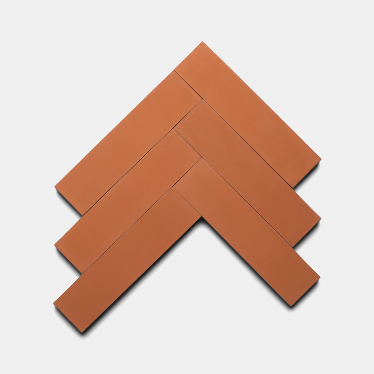Five Zia Tile Rust 2x8 rectangular terracotta tiles, arranged in a herringbone pattern on a plain light background—a stylish Rust 2x8, Sample for your next design project.